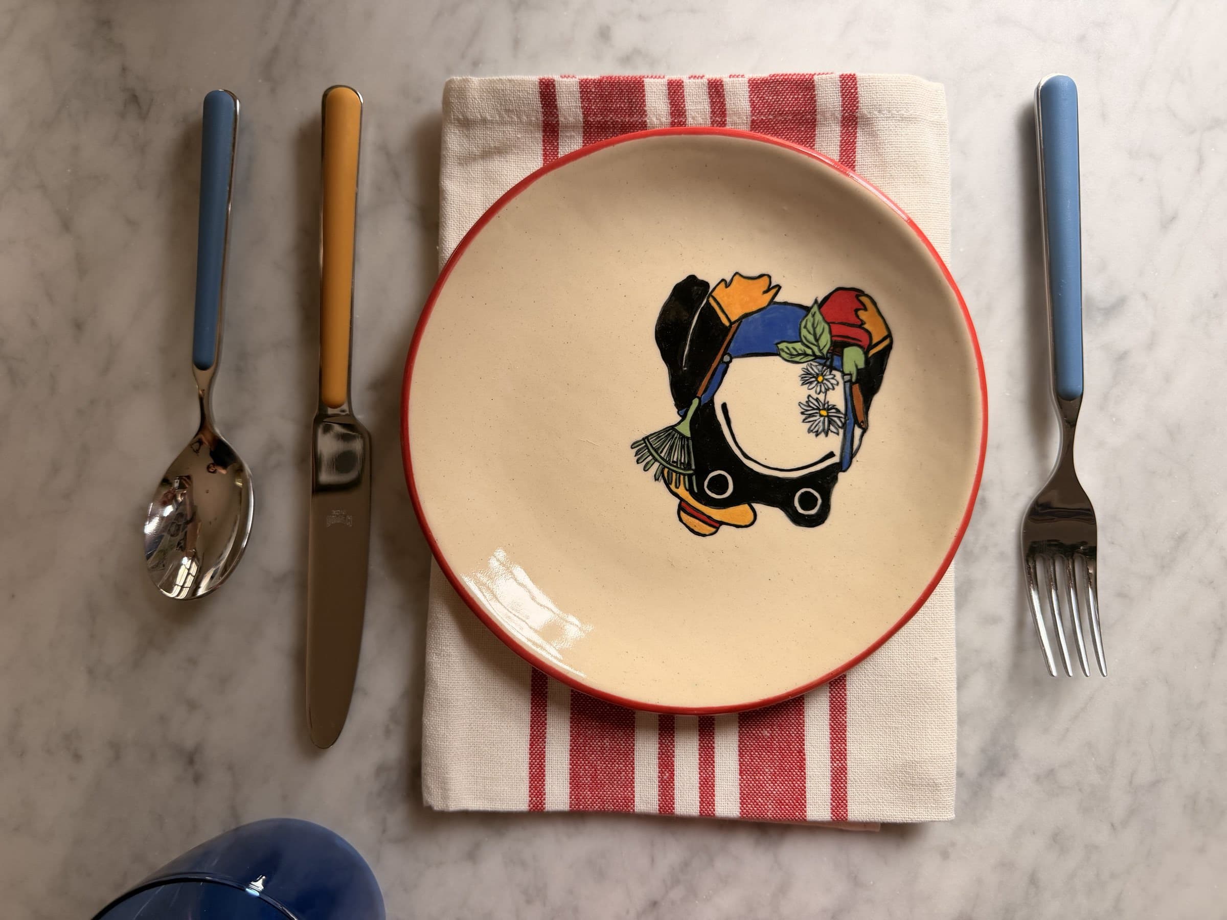 A tablescape of finished ceramics — bowls, plates, and linens.